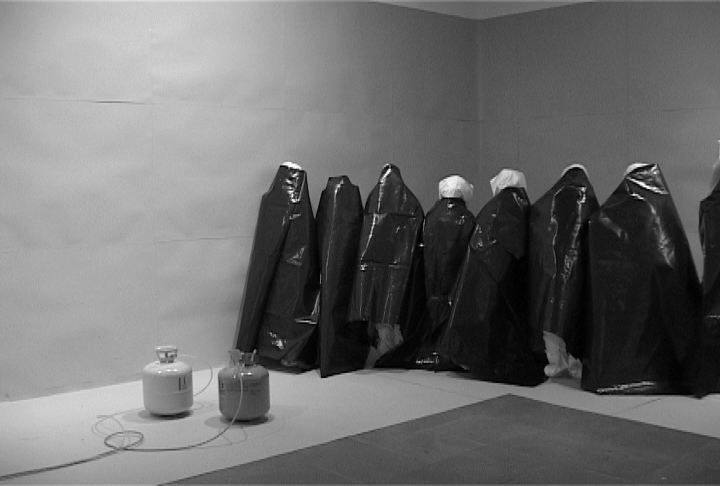 Santiago Sierra, POLYURETHANE SPRAYED ON THE BACKS OF 10 WORKERS, Lisson Gallery London, U.K., July 2004.